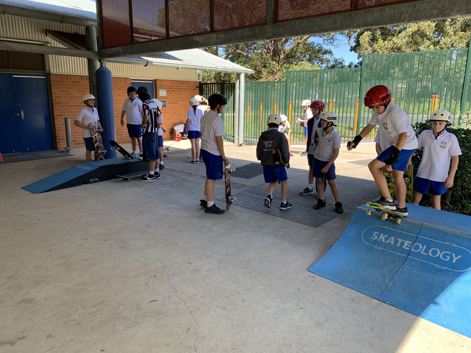 Kids skateboarding on ramps.